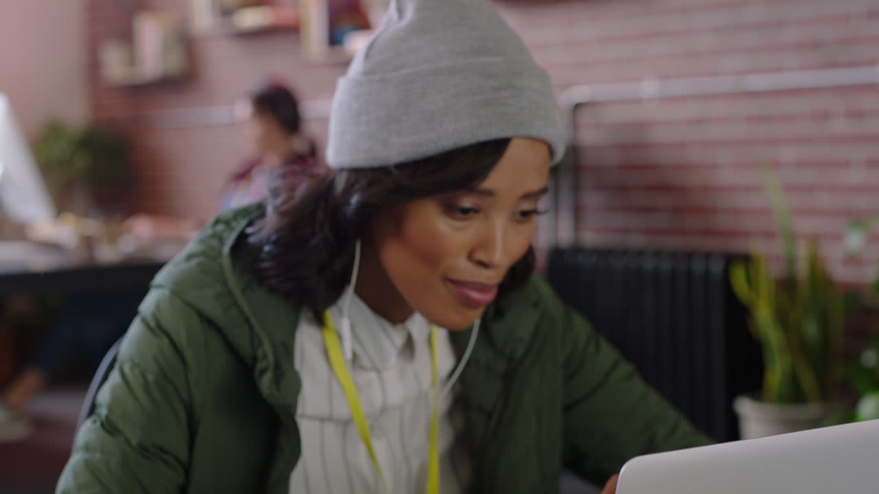 beautiful african american business woman using laptop computer video chat conversation discussing startup company enjoying conference call online communication in trendy office workplace