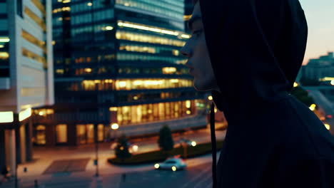 man in hoodie at night in a city