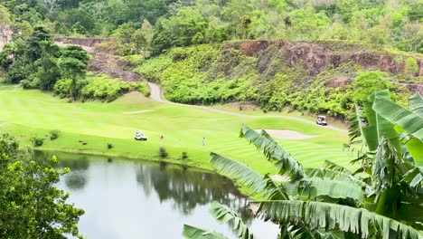 golfers playing on scenic lush golf course in phuket, thailand