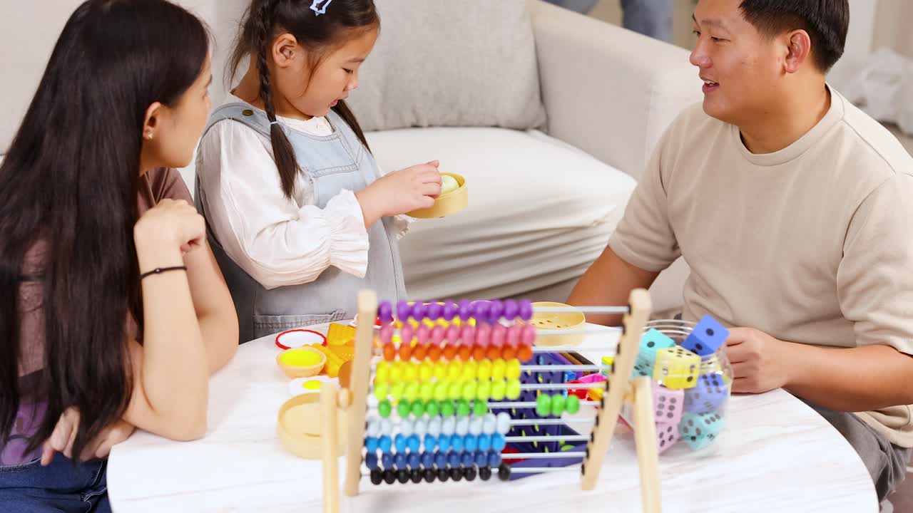 Parents and child interact with colorful educational toys in a bright, cozy living room setting