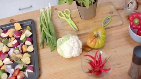 close up of vegetables, mushrooms and spices in kitchen, slow motion