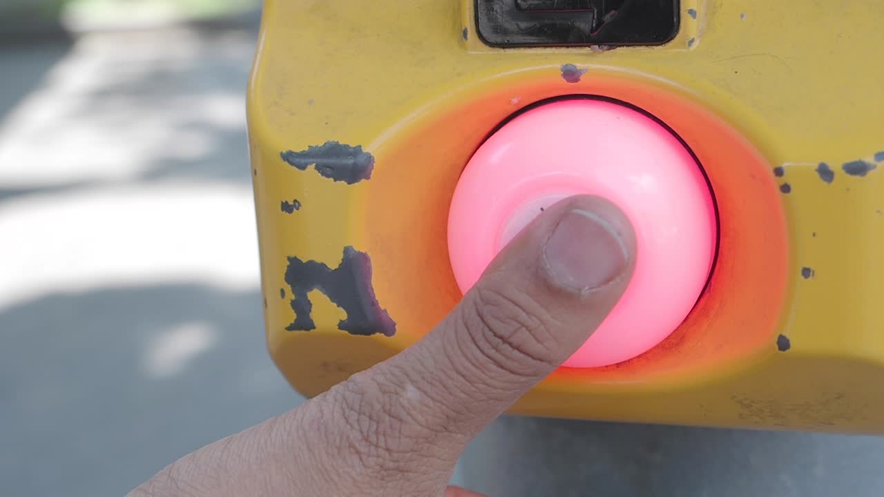 Hand Pressing Pedestrian Crossing Button