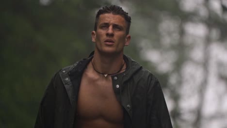 man walking in a foggy, rainy environment, with his jacket unbuttoned in the mountains of alajuela, costa rica, capturing a moment of raw connection with the wild nature