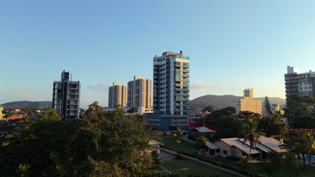 Cityscape view of Penha, Brazil with trees and buildings at sunset