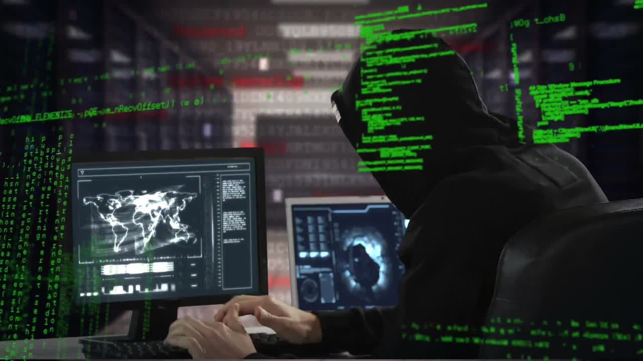 Hacker using a laptop and computer