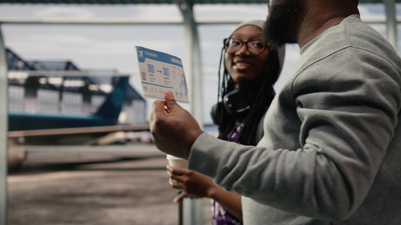 Close up of airplane ticket used by people walking in airport terminal