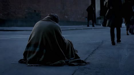 homeless person on a city street at night