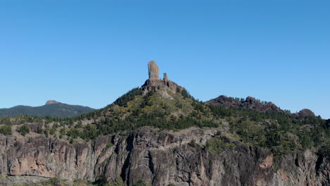 Aerial-drone-footage-of-beautiful-stunning-landscape-view-off-the-Roque-Nublo-rock-formation-and-plateau-at-Gran-Canaria-Spain-with-a-valleys-and-many-small-peaks-on-a-sunny-day