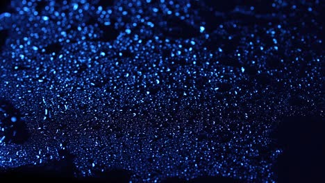 close-up footage of water drops on dark blue background