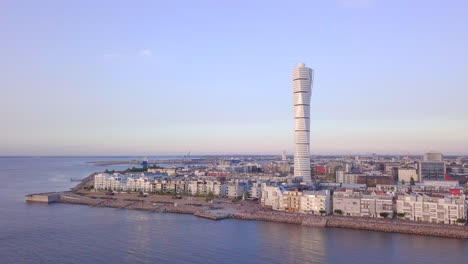 Malmo-marina-tower-drone-fly-point-of-interest-at-evening-time