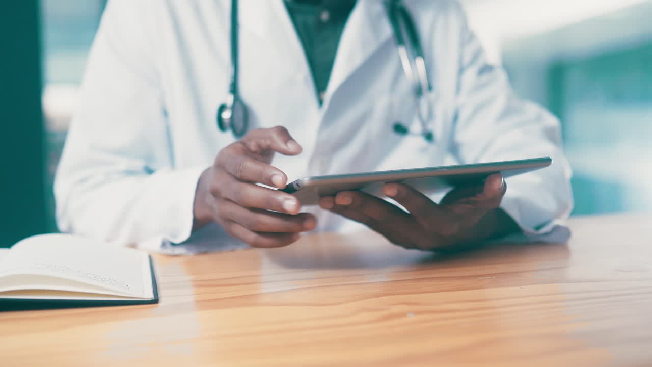 Updating his patients' medical records