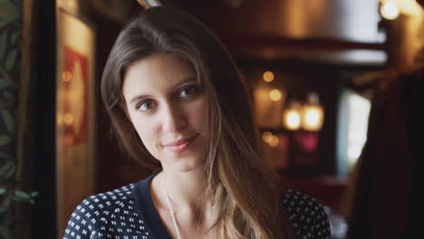 Head-And-Shoulders-Portrait-Of-Attractive-Smiling-Woman-Inside-Hotel