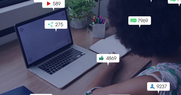 Woman creator monitoring laptop, alerts appearing as badges over screen, showing social media surge