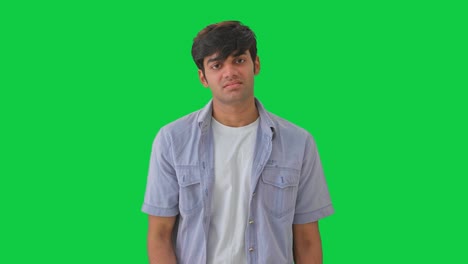 upset indian boy hitting his head green screen