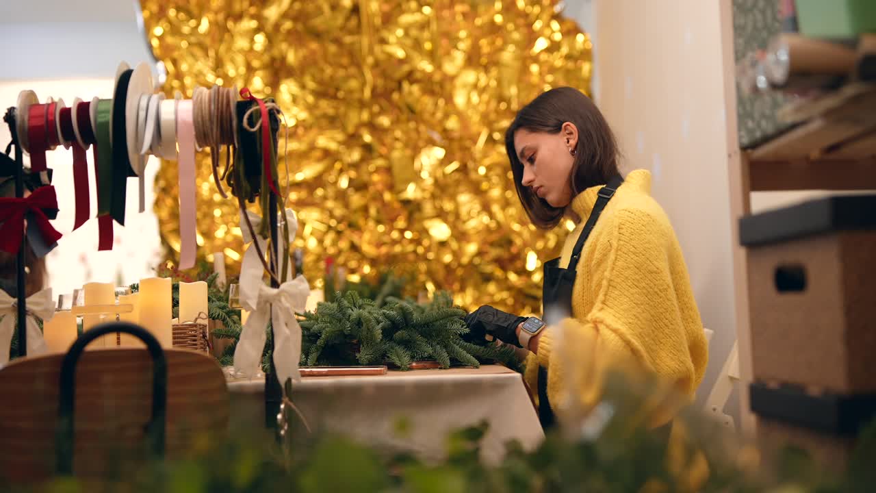 Woman Making Christmas Wreath in Workshop