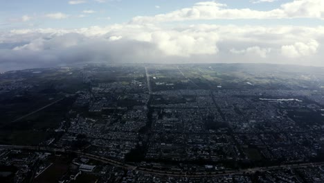 Vast-Chinese-Dali-city-sprawling-across-valley,-high-aerial-view