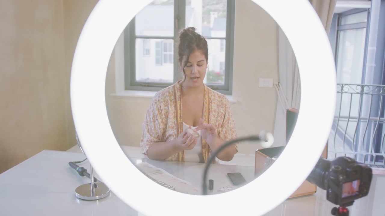 Caucasian blogger woman doing a video at home