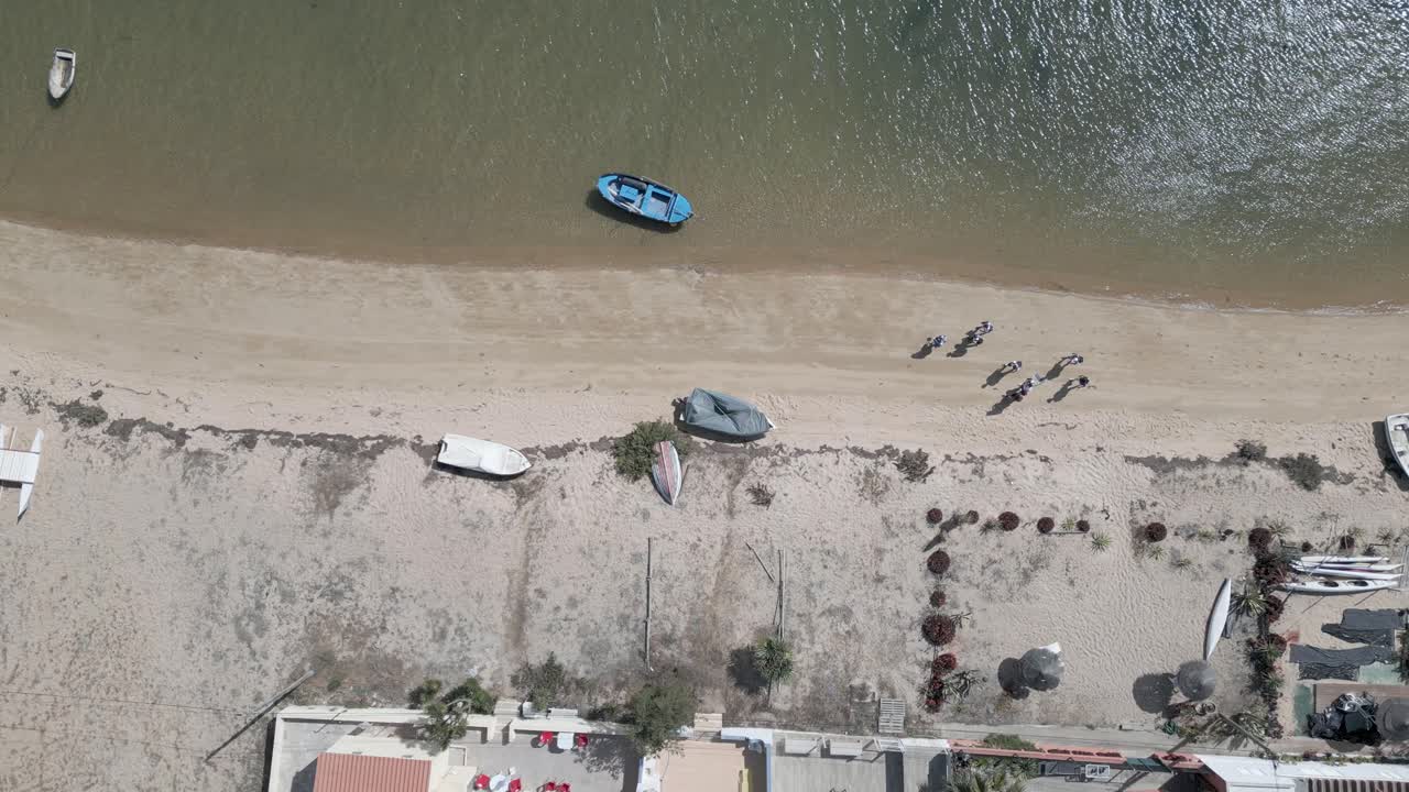 Tourists stroll on Faro Island, basking in the sunny day while exploring Portugal's beauty and charm