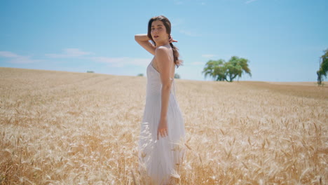 romantic girl enjoying spikelets meadow. tender woman posing summer rural nature