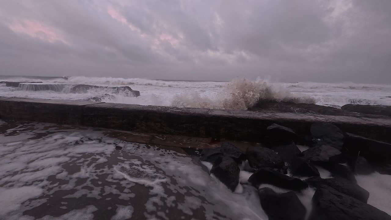 Cloudy Sky And Strong Foamy Waves Splashing At Snapper Rocks During Cyclone Alfred In Queensland, Australia. panning shot