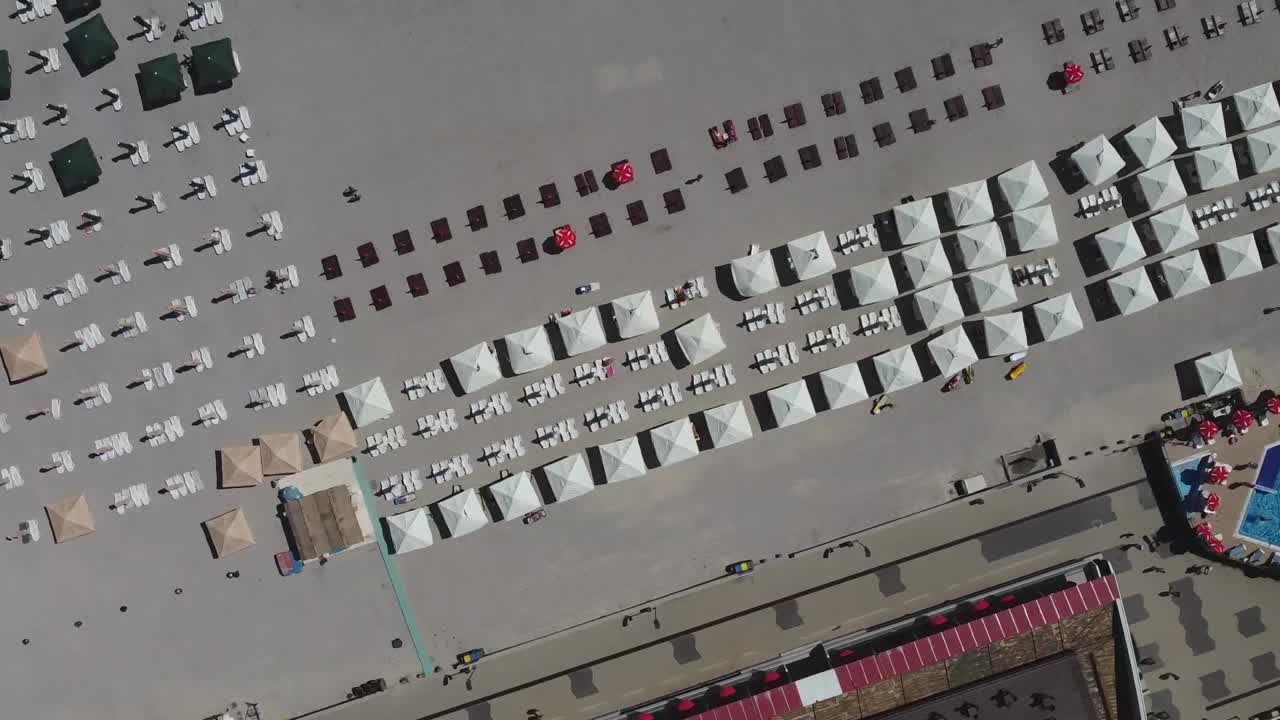 Orbiting drone shot of Mamaia Resort's beachfront, a popular tourist destination facing the Black Sea, situated in Constanta, Romania