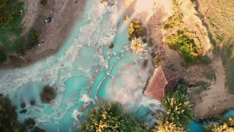 cascate del mulino, soothing natural hot springs bath, saturnia, tuscany, italy, europe, drone view traveling up, bird view, zenithal