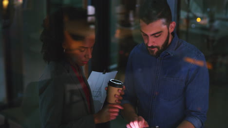 two businesspeople working together on a digital