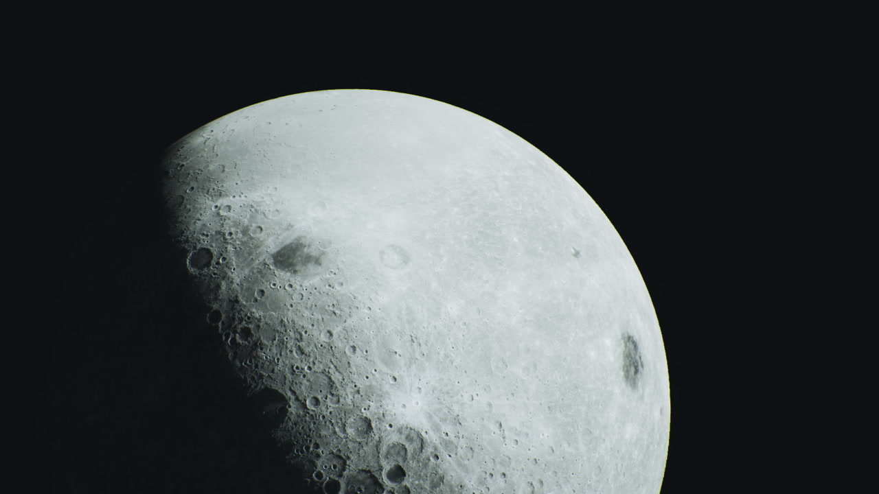 Glimpse of the moon highlighting its craters and surface details at night
