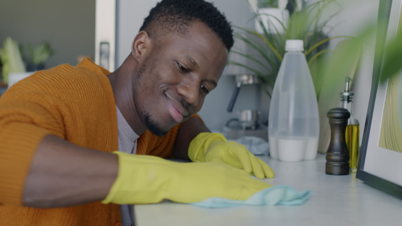 Man Cleaning Kitchen Counter
