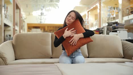 woman hugging pillow on couch