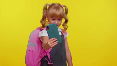 Schoolgirl-kid-blogger-in-uniform-taking-selfie,-recording-video-on-mobile-phone-for-social-media