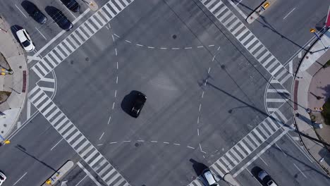 vehicles driving through intersection in busy urban metropolis