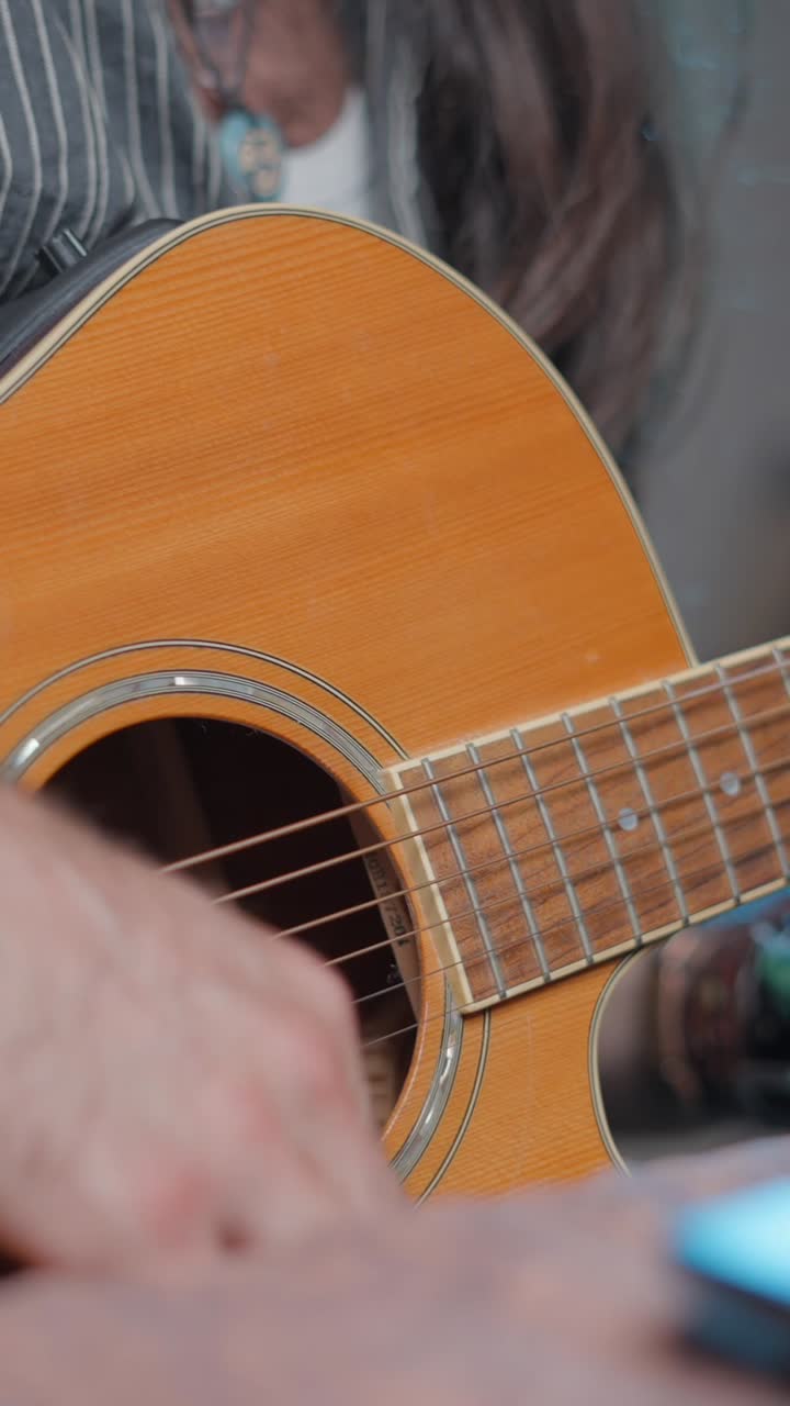 Close-up of a musician's hand playing guitar