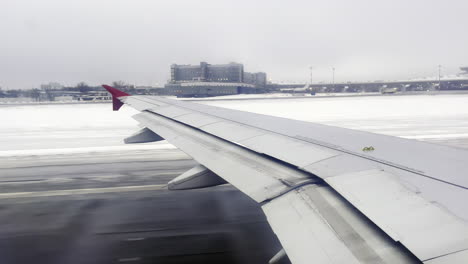 wing of an airplane taking off in winter