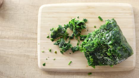 frozen spinach on cutting board