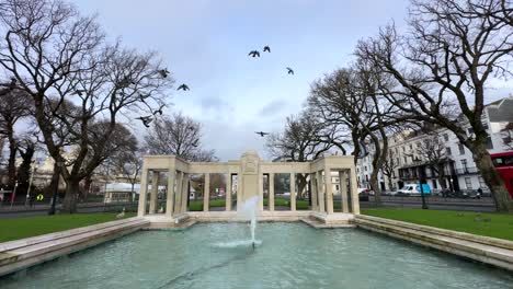 establishing shot of brighton war memorial in old steine gardens, uk