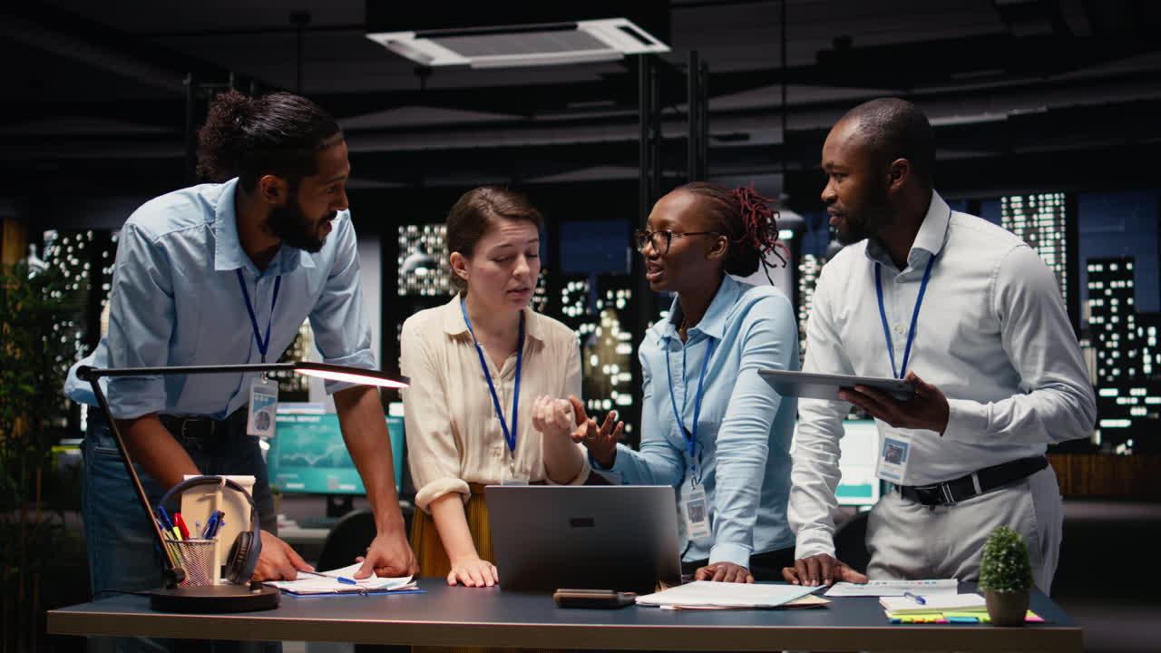 Corporate team gathered around office desk collaborating on project