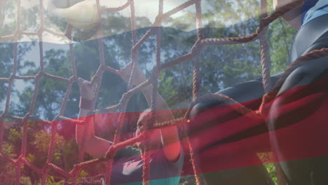 animation of flag of russina over diverse man and woman during obstacle race training