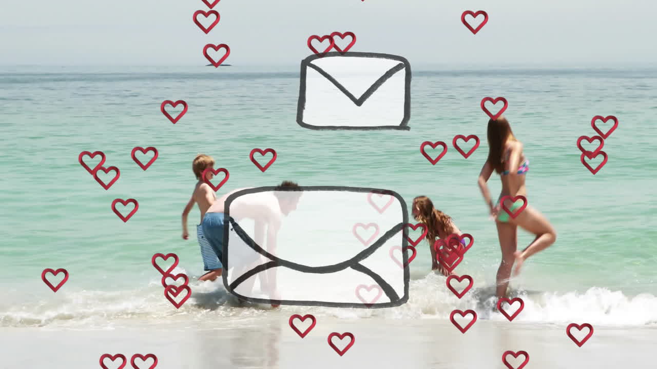 Family playing at beach with heart and envelope animation overlay