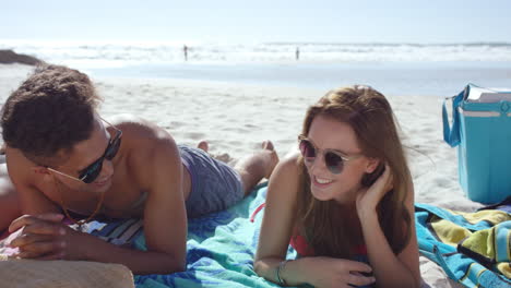 Multi-racial-couple-with-Group-of-friends-hanging-out-on-the-beach-on-summer-vacation