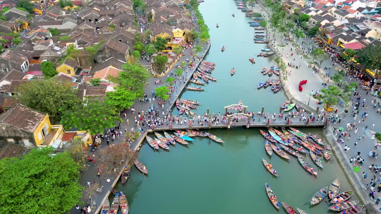 Aerial landscape of Hoi An Vietnam with bridge over the river, water boats and touristic residential area