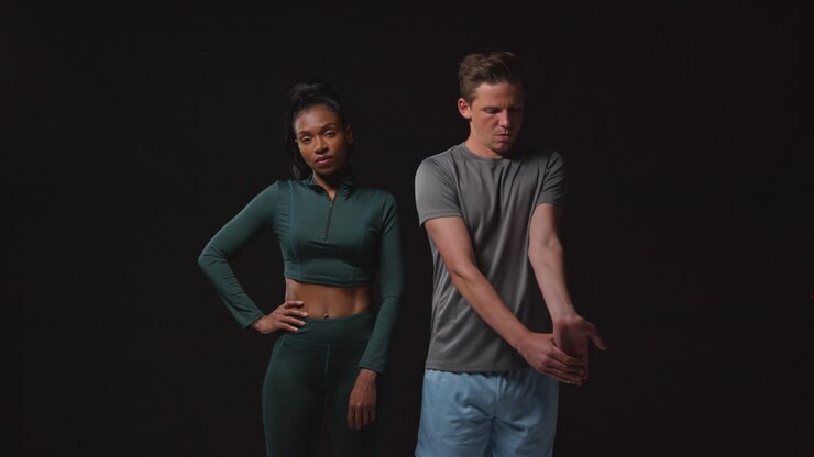 Studio Portrait Of Serious And Determined Male And Female Athletes Training In Fitness Clothing Shot Against Black Background 1
