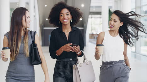 Women-friends,-talking-and-walking-in-office