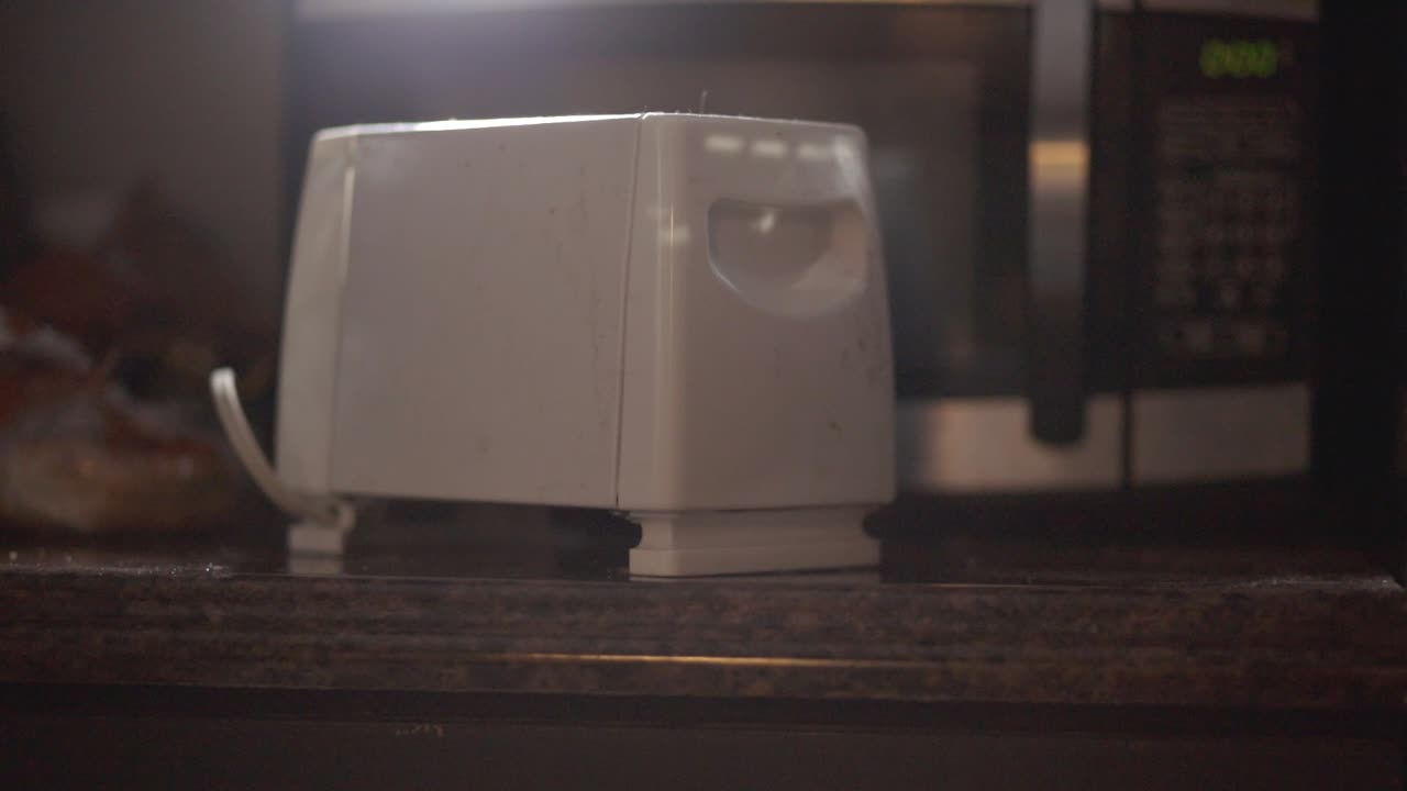 Slices Of Bread Popping Out Of The Electric Bread Toaster In The Kitchen - close up slowmo