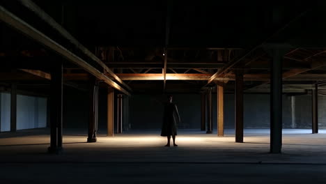 woman in an empty industrial warehouse