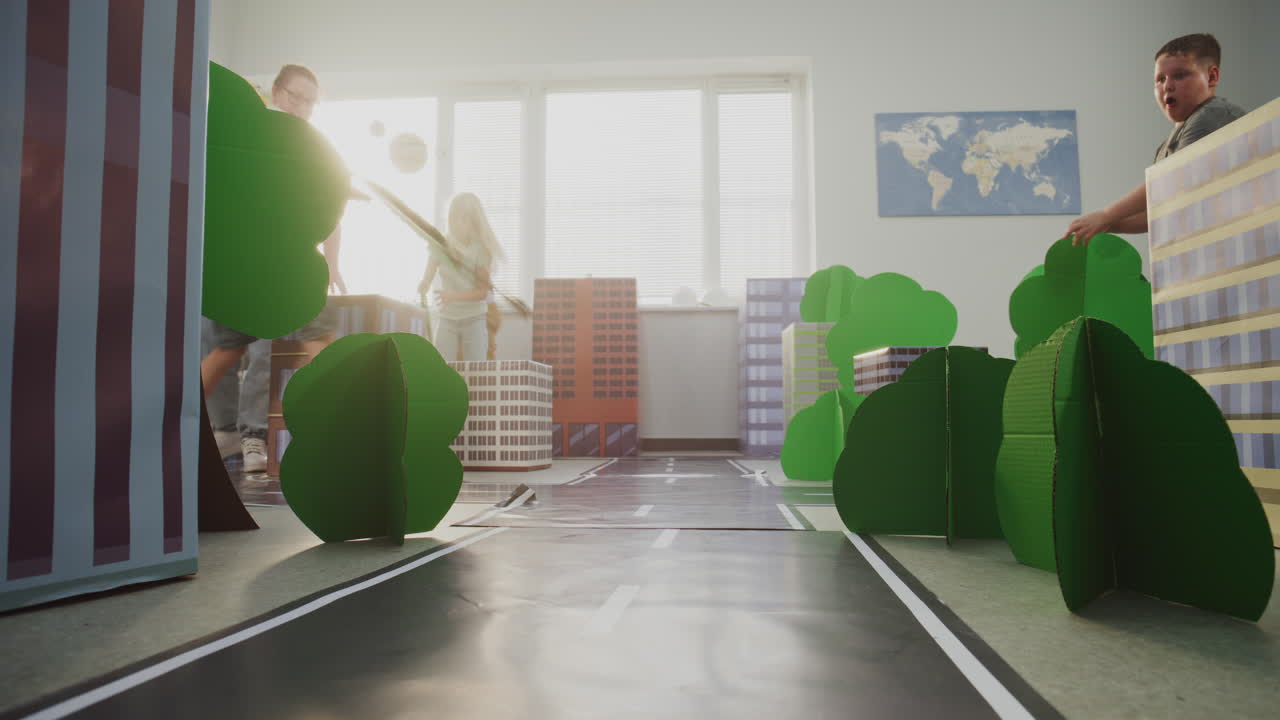 Team of Primary School Students Moving Blocks Creating City Planning