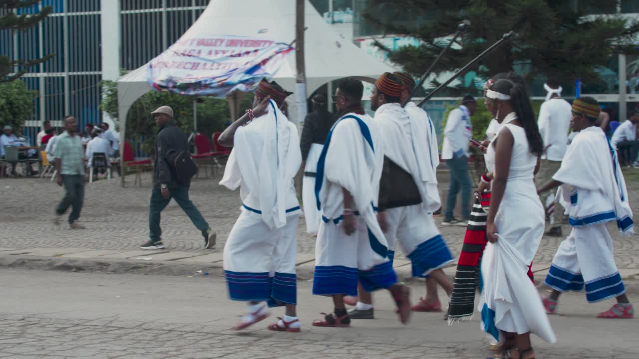 Ethiopian Oromo men and women walking in Irreecha festival wearing traditional clothes