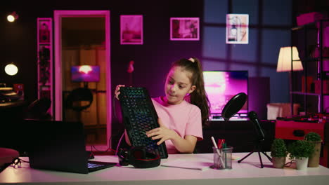 Little-girl-showcasing-computer-peripherals-to-fans-on-gen-Z-online-channel