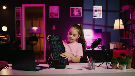 little girl showcasing computer peripherals to fans on gen z online channel