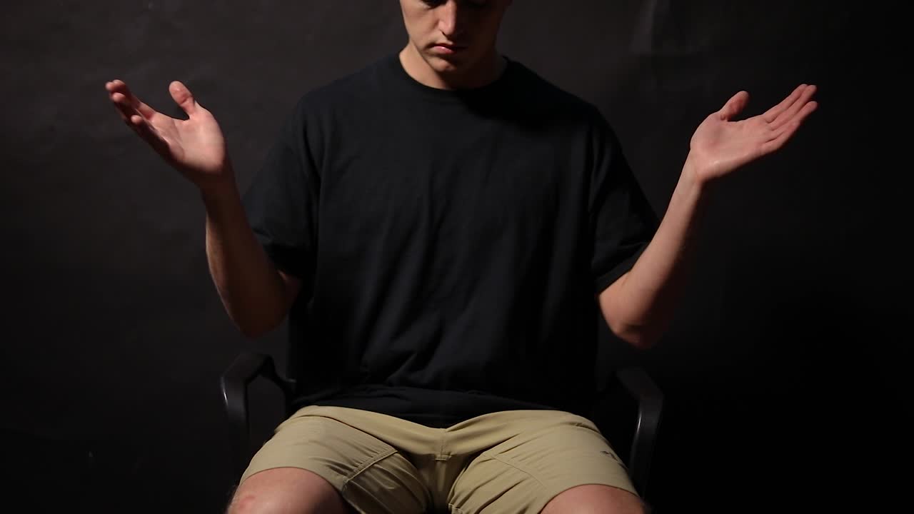 어깨를 으쓱하고 팔과 손으로 "모르겠어요" 제스처를 취하는 남자의 사진